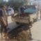 Warga saat swadaya memperbaiki sementara jalan yang berlubang di wilayah Teluknaga.