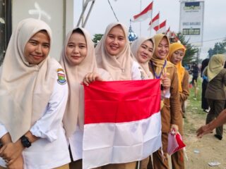 Pegawai Kecamatan Teluknaga saat membagikan bendera merah putih ke pengguna jalan raya.