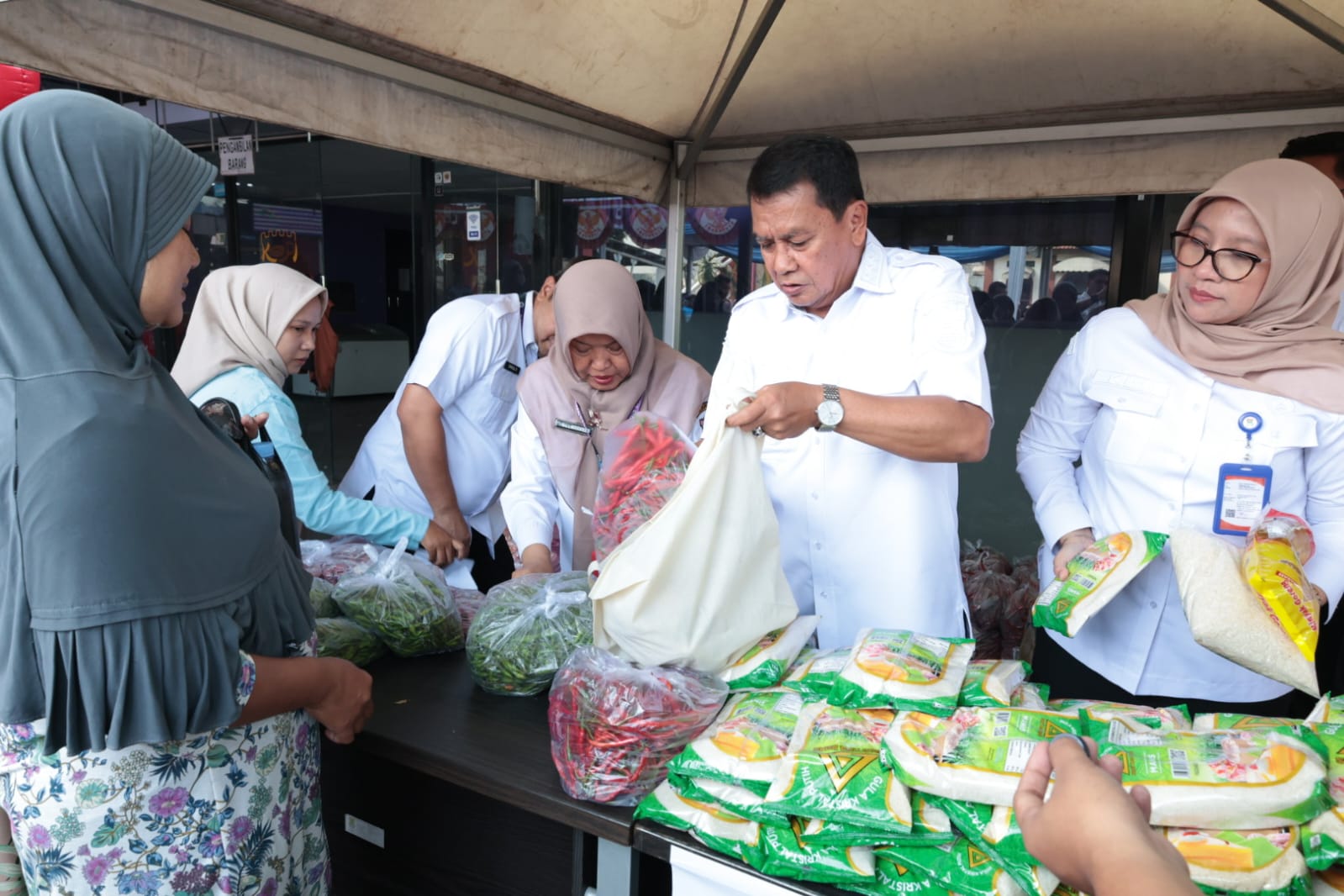 Bupati Maesyal, Kepala Disperindag Kabupaten Tangerang, Resmiyati Marningsih, saat melayani warga yang ikut kegiatan Warteksi Gemilang.